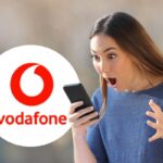 ragazza col telefono e logo vodafone