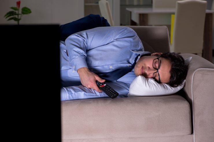 Uomo che dorme con tv accesa