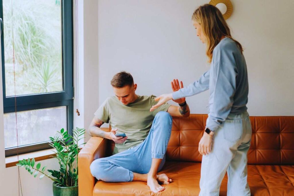 Coppia che discute con donna che indica cellulare