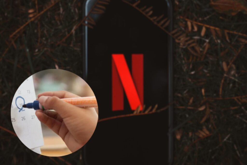 Smartphone con logo netflix su sfondo di foglie e calendario