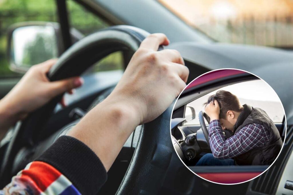 persona in auto con mani sul volante