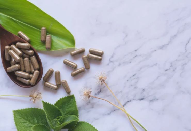 integratori alimentare su marmo con foglie