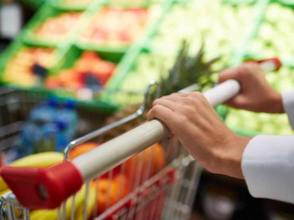mani che spingono carrello al supermercato