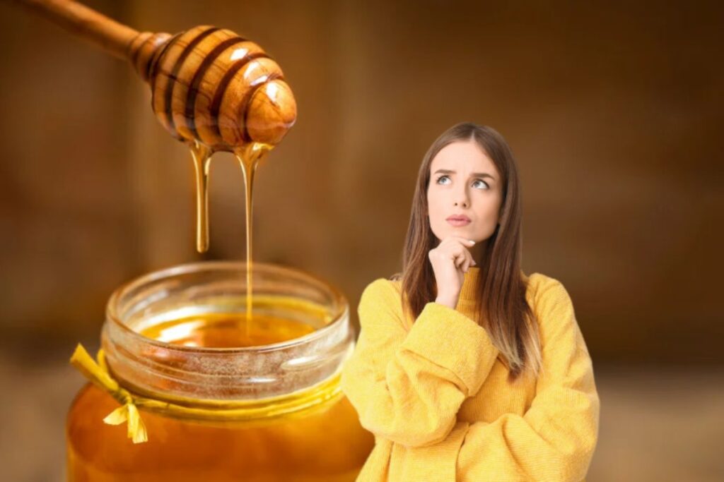 donna pensierosa con barattolo di miele