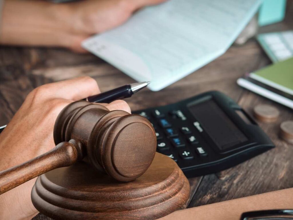 Uomo calcoli documenti martello tribunale