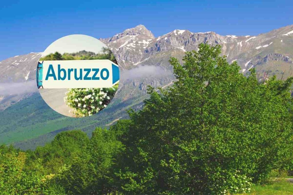 una vallata con montagne e nel cerchietto la scritta abruzzo