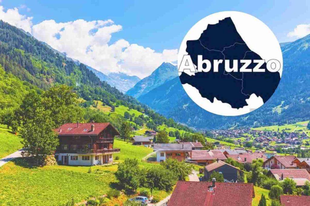 un borgo nella vallata e nel cerchietto la scritta abruzzo con la mappa