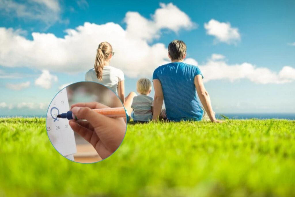 uomo donna e bambino seduti su un prato e accanto un calendario