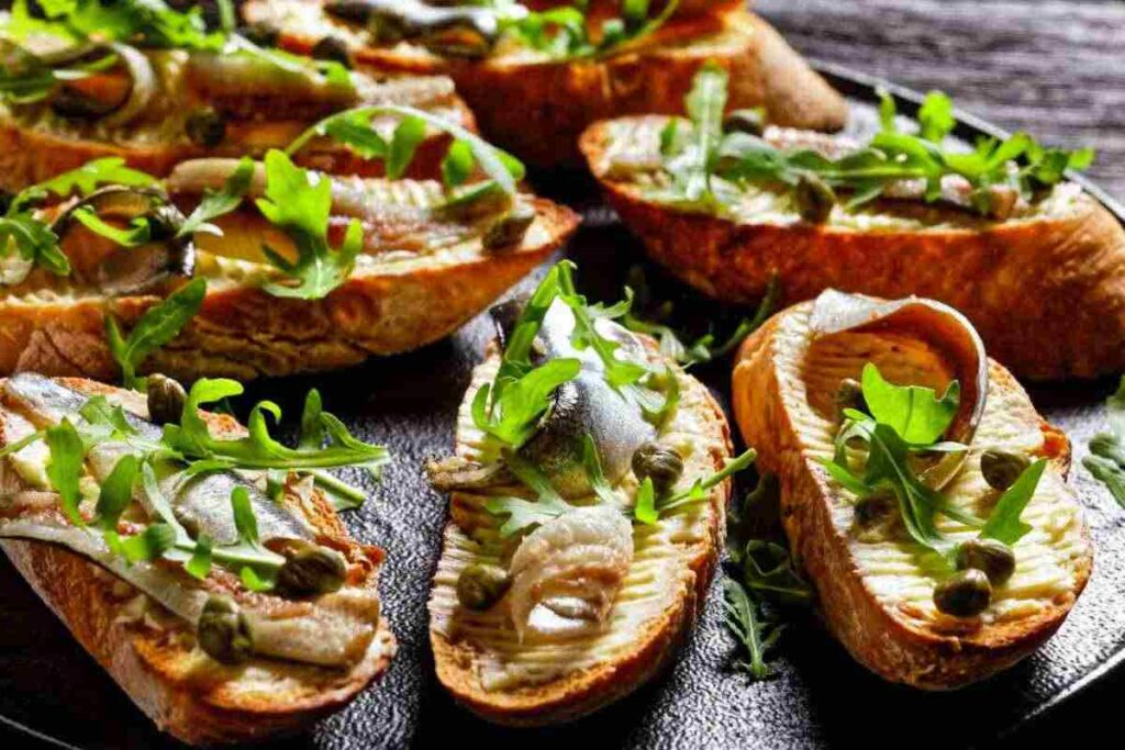 bruschette con acciughe, capperri e rucola