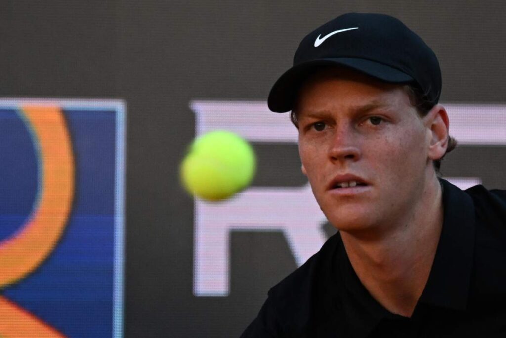 Jannik Sinner concentrato nel colpire la palla che viaggia verso lui.